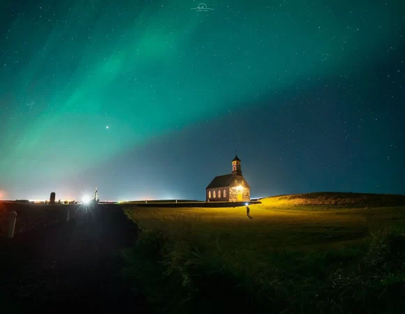 Hvalsneskirkja under the northern lights Tales and Trails